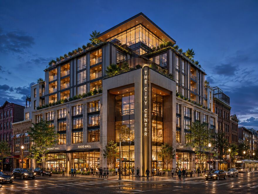 Artist's conceptual rendering of The City Center — a contemporary stone-and-glass mixed-use building wrapping the corner of Broadway and East 21st Street, Bayonne, NJ, with terraced greenery, a ground-floor market hall, food hall and café, and a glassed rooftop, at dusk. Conceptual only; storefront signage illustrative.